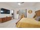 Main bedroom featuring a stylish media console, large screen TV and a bright window at 18501 W Galveston St, Goodyear, AZ 85338