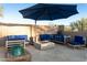 Enjoy outdoor living on the patio with comfortable seating, umbrella and a cozy fire pit at 18501 W Galveston St, Goodyear, AZ 85338