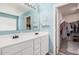 Bathroom featuring dual sinks with white cabinets, and a large mirror at 19259 N Ventana Ln, Maricopa, AZ 85138