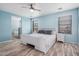 Serene bedroom with light blue walls, wood floors, and a large window at 19259 N Ventana Ln, Maricopa, AZ 85138