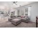 Comfortable living room with a large sectional sofa and view to the kitchen and dining area at 19259 N Ventana Ln, Maricopa, AZ 85138