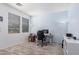 Bright office space featuring wood floors, blue accent wall, and ample natural light from a large window at 19259 N Ventana Ln, Maricopa, AZ 85138