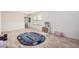 Bright playroom with wood flooring and an education-themed rug at 19259 N Ventana Ln, Maricopa, AZ 85138