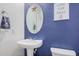 Charming powder room with blue accent wall, stylish mirror, and 'Wash Your Hands' sign at 19259 N Ventana Ln, Maricopa, AZ 85138