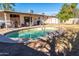 Backyard with a pool, patio, outdoor grill, and shed at 1926 E El Moro Ave, Mesa, AZ 85204