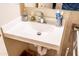 Practical bathroom featuring a white sink and cabinet with tiled walls and a metal grab bar at 1926 E El Moro Ave, Mesa, AZ 85204