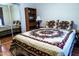 Calm bedroom featuring wood-look floors, a bed with decorative quilt, and a mirrored closet at 1926 E El Moro Ave, Mesa, AZ 85204