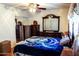 Bedroom with dark wood furniture and a sliding door closet at 1926 E El Moro Ave, Mesa, AZ 85204