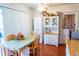 Eat-in kitchen area with white cabinets and table with four wooden chairs at 1926 E El Moro Ave, Mesa, AZ 85204