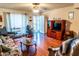 Bright living room with light colored walls, wood-look flooring, a ceiling fan, and access to the front entrance at 1926 E El Moro Ave, Mesa, AZ 85204