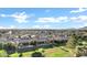 A high aerial shot highlights the house and its relation to the houses and greenways around the property at 20207 N Riverbank Rd, Maricopa, AZ 85138