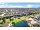 An aerial view of a neighborhood with well-maintained houses, green spaces, and a serene pond, creating a harmonious community at 20207 N Riverbank Rd, Maricopa, AZ 85138