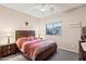 Cozy bedroom featuring a ceiling fan, neutral tones, a comfortable bed, and window with neighborhood views at 20207 N Riverbank Rd, Maricopa, AZ 85138