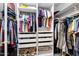 Well-organized walk-in closet with shelving, hanging rods, drawers, and baskets for optimal storage at 20207 N Riverbank Rd, Maricopa, AZ 85138