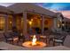 Cozy outdoor fire pit featuring comfortable seating, ideal for relaxation and enjoying the evening ambiance at 20207 N Riverbank Rd, Maricopa, AZ 85138