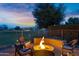 Charming outdoor fire pit area with comfortable seating, perfect for cozy evenings and entertainment at 20207 N Riverbank Rd, Maricopa, AZ 85138