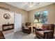 Relaxing room showcasing two comfortable recliners, side tables, and a well-lit window for a tranquil ambiance at 20207 N Riverbank Rd, Maricopa, AZ 85138