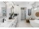 Bright bathroom with dual sinks, a freestanding tub, and a glass-enclosed shower at 21432 N 77Th Pl, Scottsdale, AZ 85255