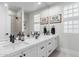 Bathroom with dual sinks, vanity with white countertops, and dark hardware at 21432 N 77Th Pl, Scottsdale, AZ 85255