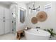 Bright bathroom featuring a soaking tub, modern fixtures, and decorative wall accents at 21432 N 77Th Pl, Scottsdale, AZ 85255