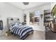 Bedroom with natural light, built-in shelving, and a cozy blue and white striped bed at 21432 N 77Th Pl, Scottsdale, AZ 85255