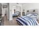 Bedroom with sliding mirror closet doors and blue and white stripped bed at 21432 N 77Th Pl, Scottsdale, AZ 85255