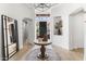 Bright foyer featuring a round table with a statue and flowers, with a view of the front entrance at 21432 N 77Th Pl, Scottsdale, AZ 85255