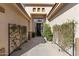 Inviting front entrance with a walkway lined with greenery and a modern-style front door at 21432 N 77Th Pl, Scottsdale, AZ 85255