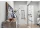 Bright hallway featuring a wood accent table and views of a bathroom and hallway at 21432 N 77Th Pl, Scottsdale, AZ 85255