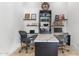 Bright home office featuring a Quartz countertop workspace, floating shelves, and modern decor at 21432 N 77Th Pl, Scottsdale, AZ 85255