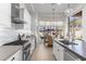 Well-lit kitchen features stainless steel appliances, modern backsplash, and seamless transition to outdoor dining at 21432 N 77Th Pl, Scottsdale, AZ 85255