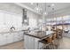 Bright, spacious kitchen with white cabinetry, stainless steel appliances, large island and pendant lighting at 21432 N 77Th Pl, Scottsdale, AZ 85255