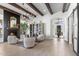 Bright, open living room with fireplace, beamed ceilings, modern lighting, and an open floor plan at 21432 N 77Th Pl, Scottsdale, AZ 85255