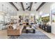 Bright living room with bar seating to the kitchen, modern light fixtures, and an open concept living space at 21432 N 77Th Pl, Scottsdale, AZ 85255