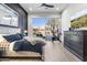 Well-lit main bedroom with a view of the backyard, accent wall, and modern decor at 21432 N 77Th Pl, Scottsdale, AZ 85255