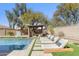 Backyard oasis features a pool, sun loungers, shaded pergola with seating, and mature landscaping at 21432 N 77Th Pl, Scottsdale, AZ 85255