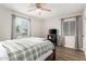 Bright bedroom with a ceiling fan, wood floors, and a plaid comforter at 217 W Montecito Ave, Phoenix, AZ 85013