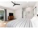 Bright bedroom featuring wood-look floors, ceiling fan, dresser, sliding glass door with backyard views at 217 W Montecito Ave, Phoenix, AZ 85013