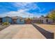 View of a blue house with red door, carport, and decorative rock landscaping at 217 W Montecito Ave, Phoenix, AZ 85013