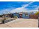 Charming blue home featuring a red front door and low maintenance desert landscaping at 217 W Montecito Ave, Phoenix, AZ 85013