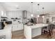 Bright kitchen features white cabinets, stainless appliances, island with quartz countertop and decorative tile backsplash at 217 W Montecito Ave, Phoenix, AZ 85013