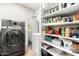 Laundry room with a modern washer and dryer, water heater, freezer, and shelving for storage at 217 W Montecito Ave, Phoenix, AZ 85013