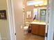 Well-lit bathroom with a shower, vanity, and ample storage at 23034 N Pedregosa Dr, Sun City West, AZ 85375