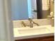 Vanity in bathroom with marble countertop and chrome faucet, with white towels and wall mirror at 23034 N Pedregosa Dr, Sun City West, AZ 85375