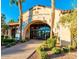 Grand entrance to the Corte Bella Golf Club, framed by palm trees and manicured landscaping at 23034 N Pedregosa Dr, Sun City West, AZ 85375