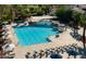 Aerial view of the community pool featuring lap lanes, ample seating, and shaded areas at Corte Bella at 23034 N Pedregosa Dr, Sun City West, AZ 85375