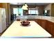 Open concept kitchen includes stainless steel appliances and marble countertops that flow into living area at 23034 N Pedregosa Dr, Sun City West, AZ 85375