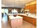 Spacious kitchen with an island and marble countertops opens into a dining and living area at 23034 N Pedregosa Dr, Sun City West, AZ 85375