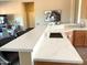 Kitchen sink area featuring quartz countertops, a white faucet, and bar seating at 23034 N Pedregosa Dr, Sun City West, AZ 85375