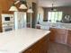 Bright kitchen featuring quartz countertops, an island, and stainless appliances at 23034 N Pedregosa Dr, Sun City West, AZ 85375